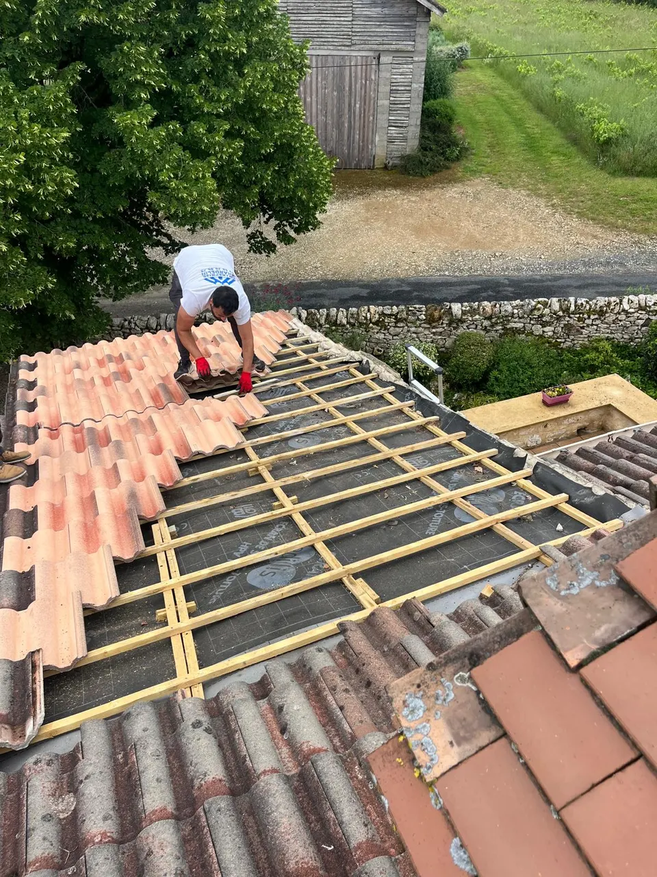 Repose des tuiles sur liteaunage neuf à Bressols, après dépose complète et pose de l'écran de sous-toiture